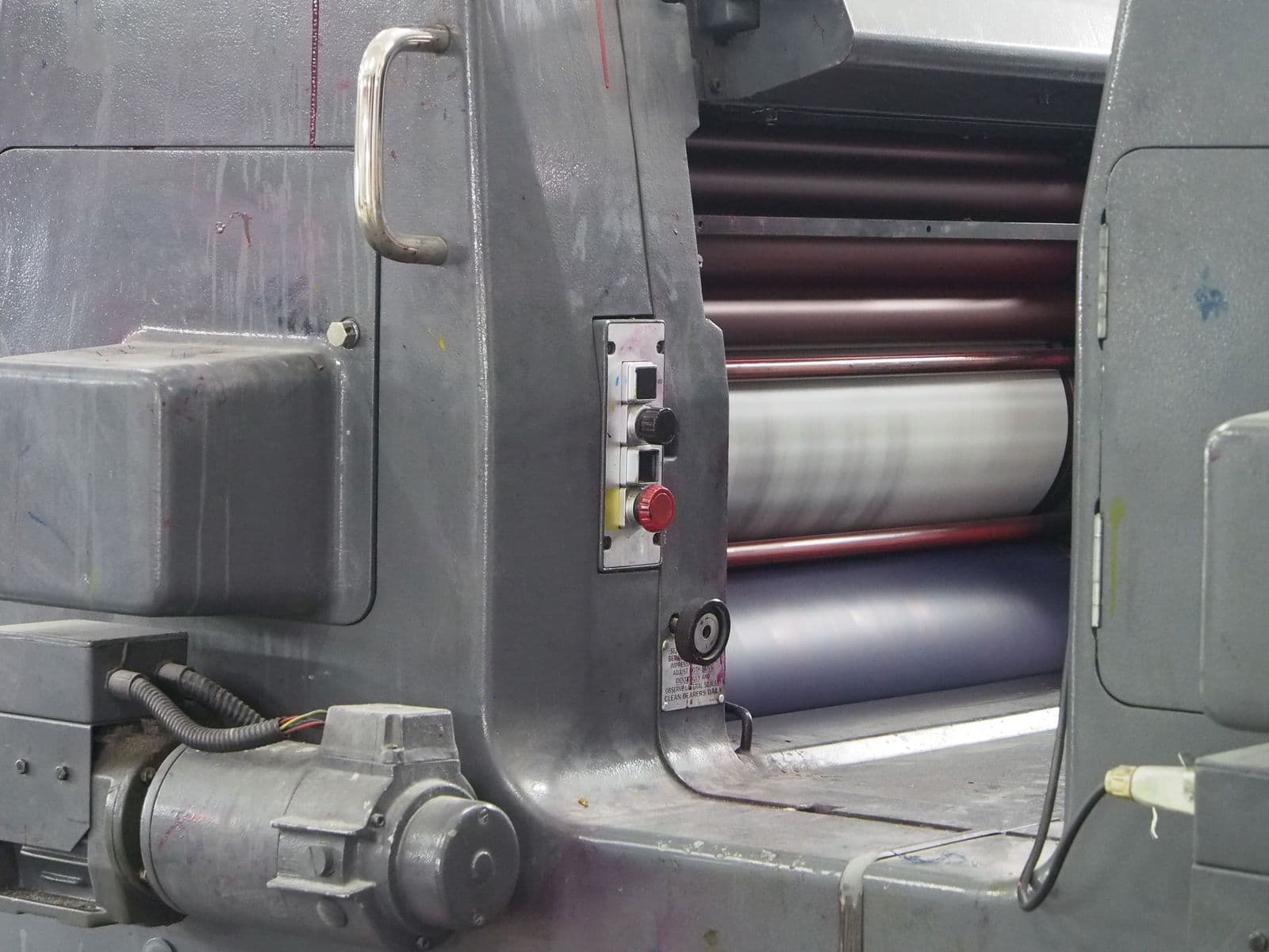 Inked rollers on a running press